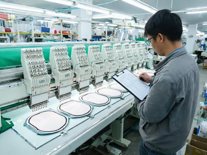 Operator loading sequence documented at an embroidery machine